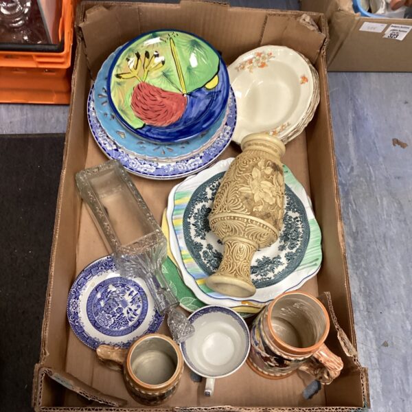 Mixed lot of vintage pottery and porcelain pieces on display.