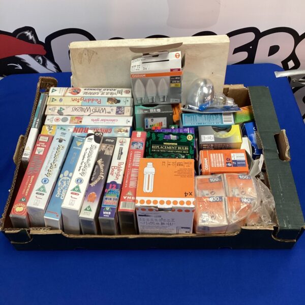 Mixed lot of VHS tapes, DVDs, and light bulbs for collectors.