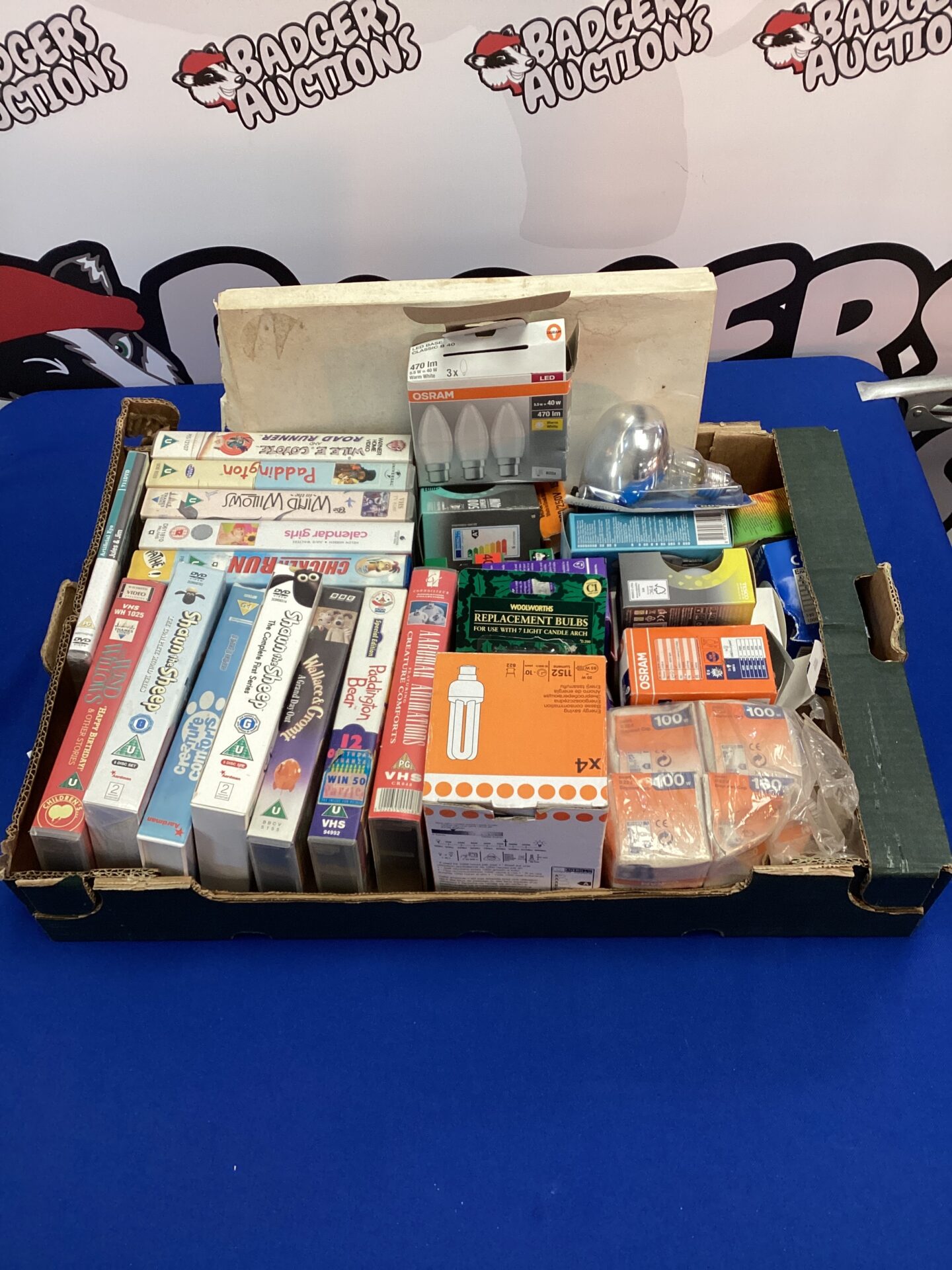654 Tray of mixed vhs, dvds & light bulbs