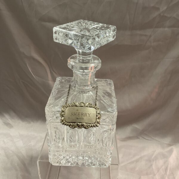 Antique crystal decanter with hallmarked silver sherry label.