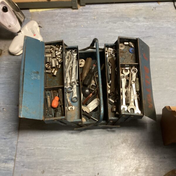 Vintage metal cantilever tool box with tools inside.