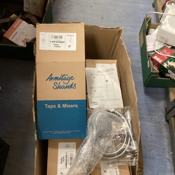 Box of vintage Armitage Shanks shower heads for bathroom restoration.