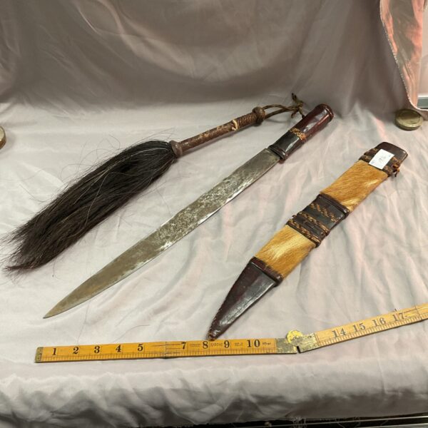 Mid-century West African sword and fly whisk set, ethnographic collectible.