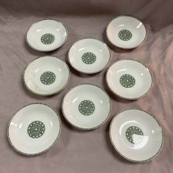 Group of Hermes Early America porcelain dishes on a neutral background.