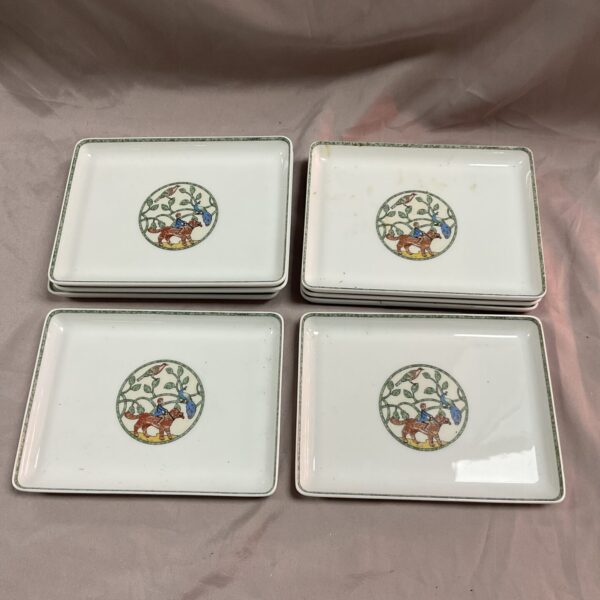 Set of eight Hermes Paris America pattern porcelain dishes, one repaired.