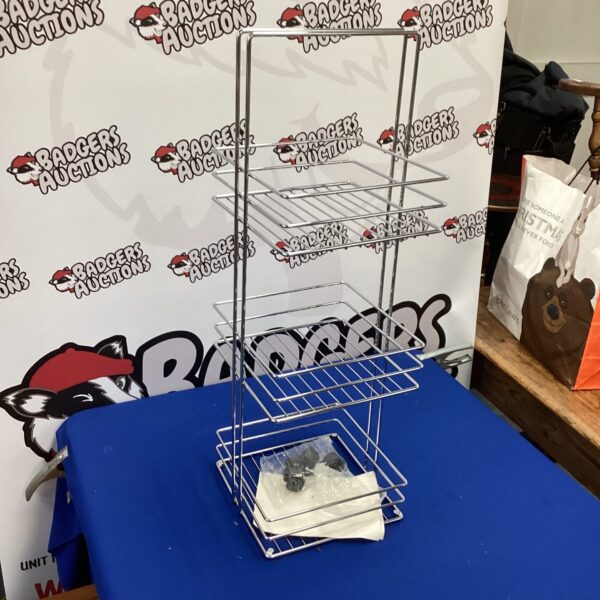 Chrome bathroom caddy on wheels with wire mesh shelves.