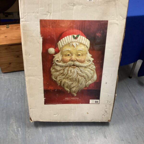 Vintage wall hanging Santa face for Christmas decoration.