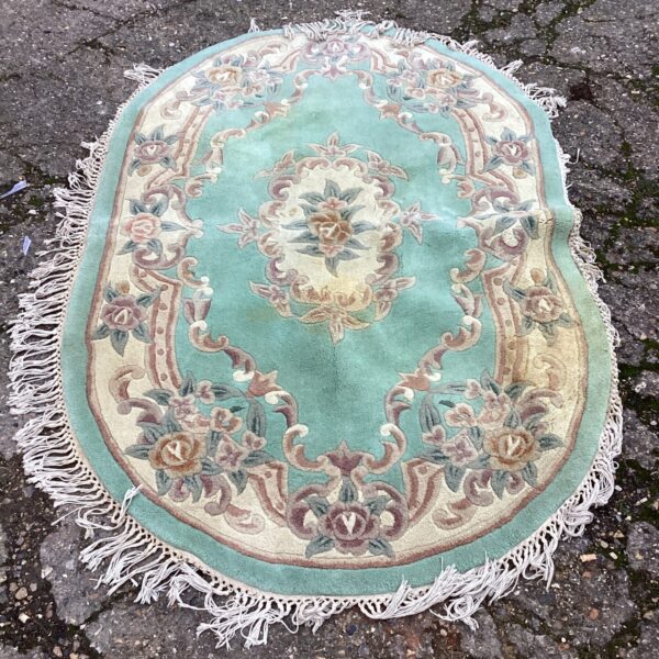 Vintage oval floral rug with detailed pattern.