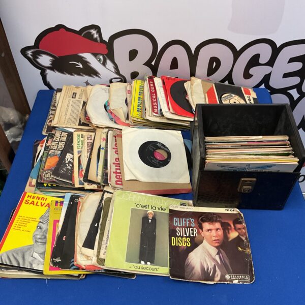Vintage 7” vinyl records featuring Cliff Richard and Johnny Hallyday.