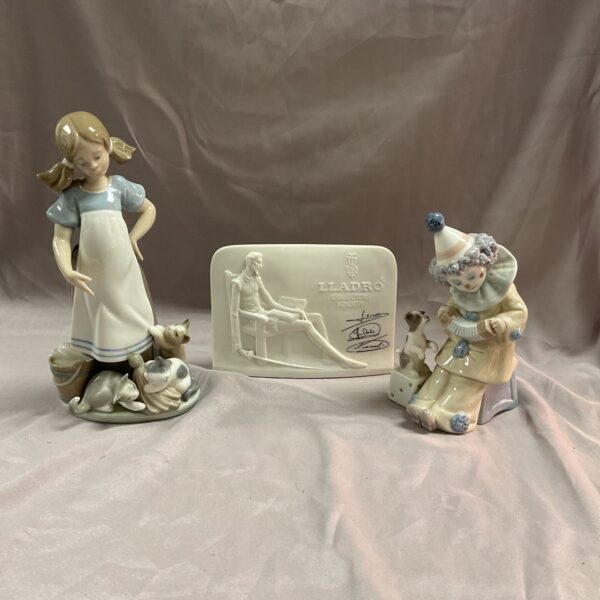 Vintage Lladro figurine of a girl with two cats, delicate porcelain.