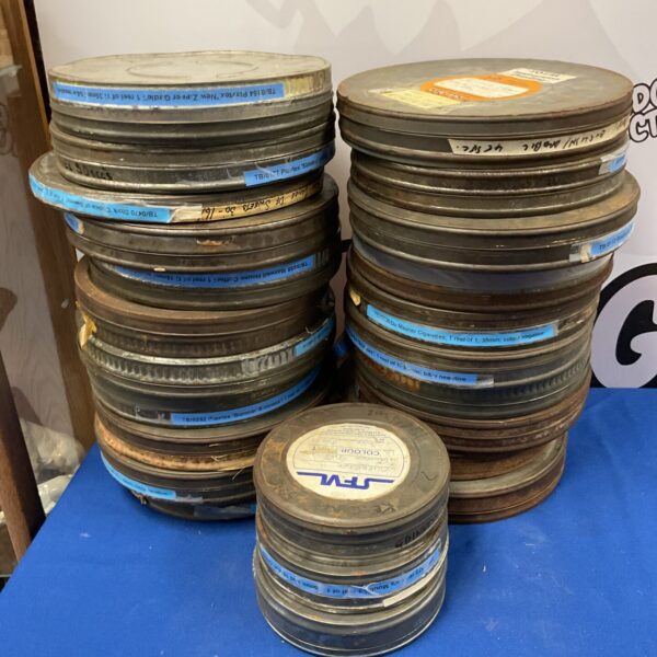 Vintage 35mm film reels with Maxwell House and Du Maria advertising.
