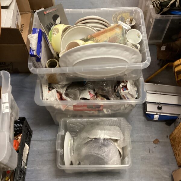 Mixed kitchenware lot with plates, cups, and bowls in boxes.