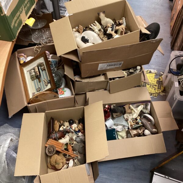 House clearance lot with boxes of mixed ornaments and household items.