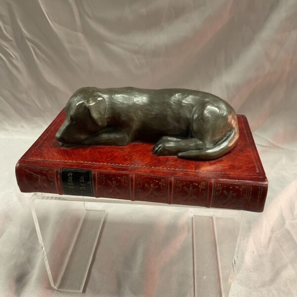 Vintage bronzed dog paperweight by Book Works Ltd on a book.