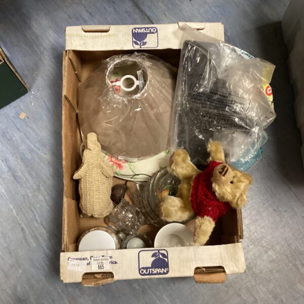 Tray of mixed home decor items including a teddy bear.