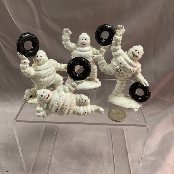 Vintage cast iron Michelin Man figures, collectible automobilia.