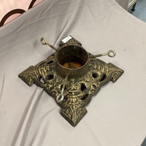 Ornate vintage metal Christmas tree stand with tightening screw.