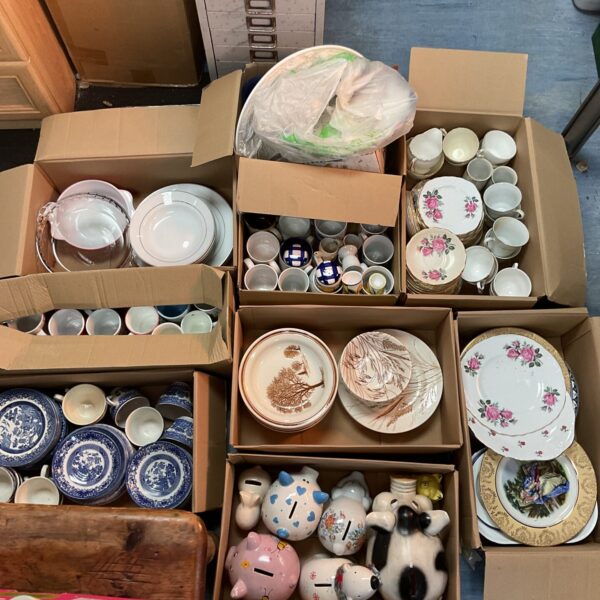 Vintage porcelain collectibles lot with plates, mugs, and figurines.