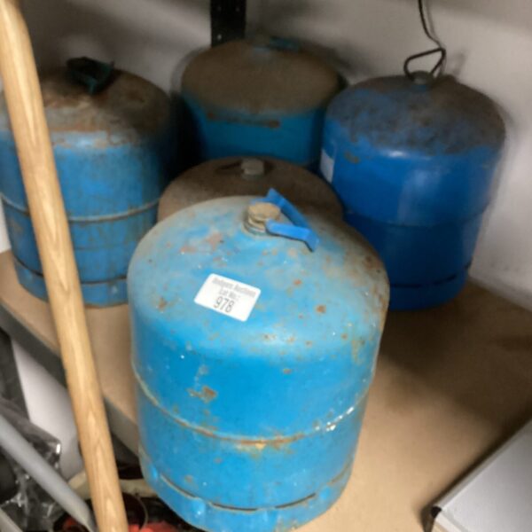 Lot of five blue industrial gas bottles for sale.