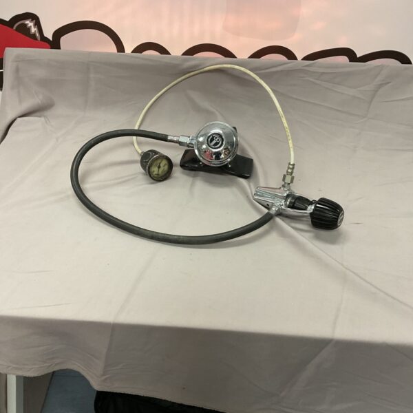 Vintage breathing regulator with pressure gauge and black hose.