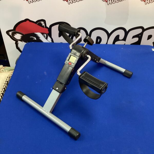 Front view of a static exercise pedal machine for home fitness.