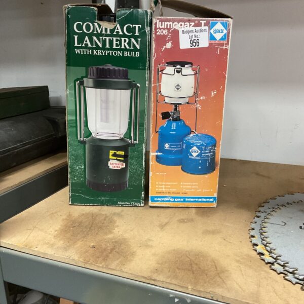 Two compact gas and battery lanterns in original packaging.