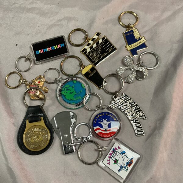 Collection of novelty keyrings including Birmingham and Hollywood designs.
