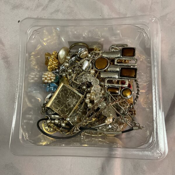 Tray of vintage costume jewellery with necklaces and brooches.