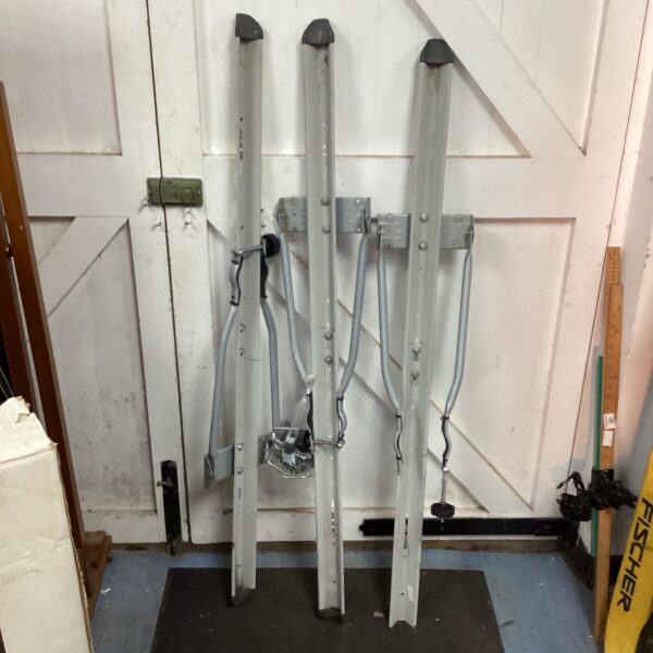 Silver wall-mounted bike racks for bicycle storage.