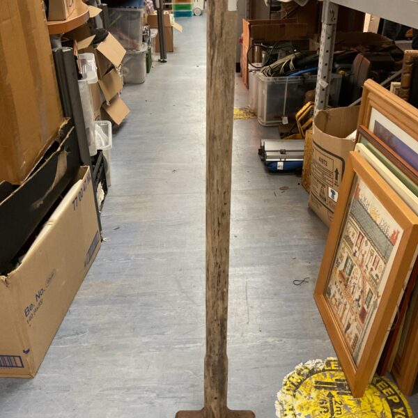Vintage sledge hammer with a worn wooden handle and steel head.