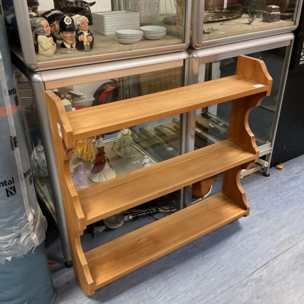 Three-tier pine wall shelves for rustic home decor.