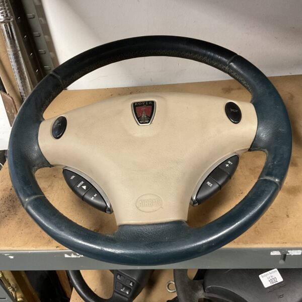 Rover 75 steering wheel with woodgrain finish and logo.