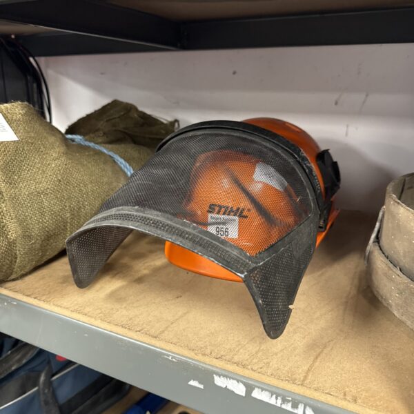 Stihl gardeners helmet with face protector, showing signs of wear.