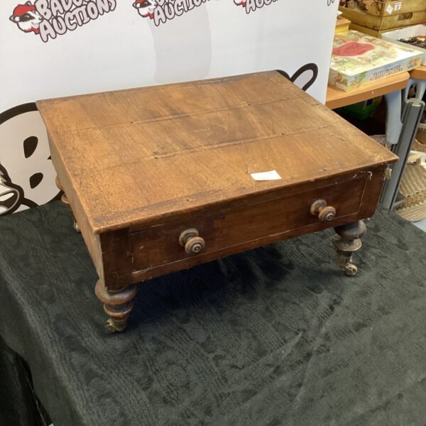 Antique elm cabinet with a single drawer and casters.