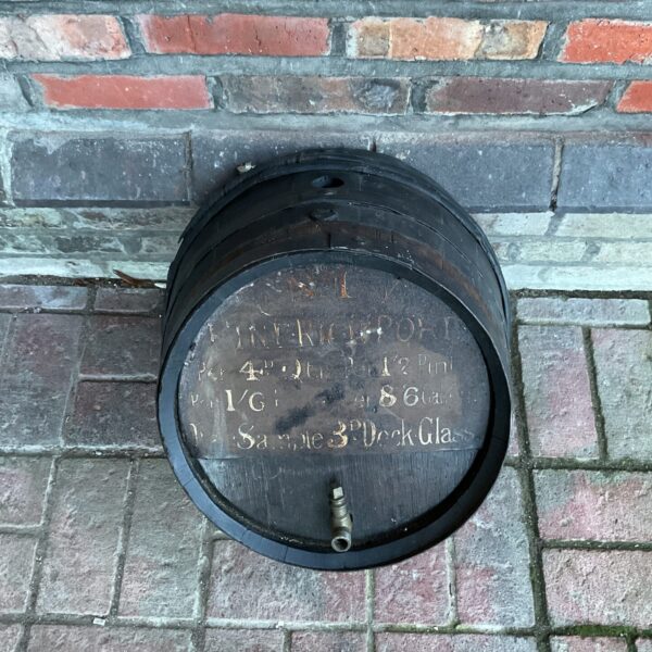 Antique pub port barrel with faded lettering, vintage tavern decor.