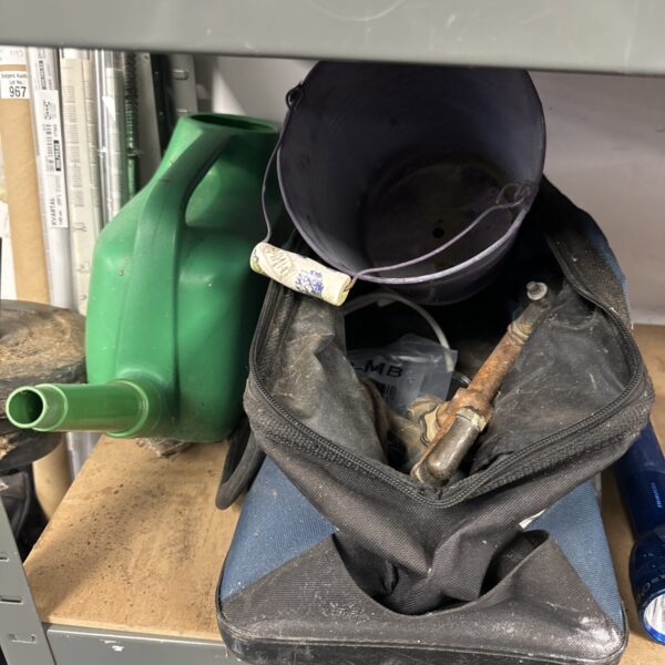 Dark Rubbermaid gardening tool bag filled with various tools.