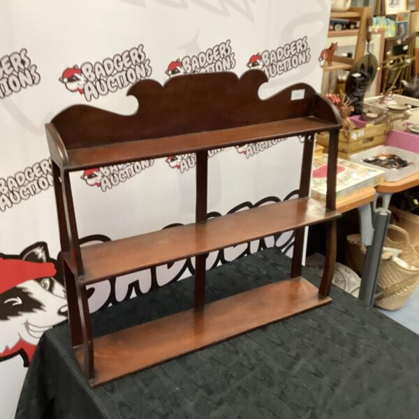 Antique mahogany shelf unit with three tiers for display.
