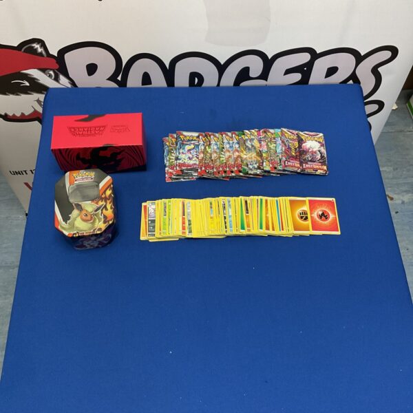 Pokemon card collection lot with booster packs and tin.
