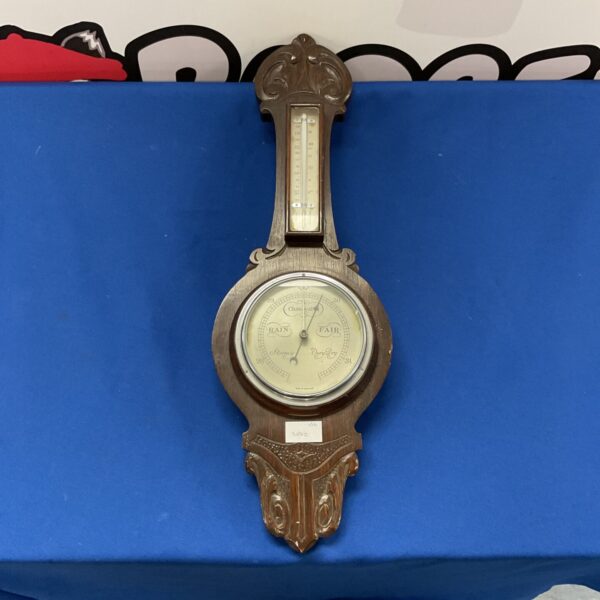Antique Victorian mercury barometer with brass casing and glass front.