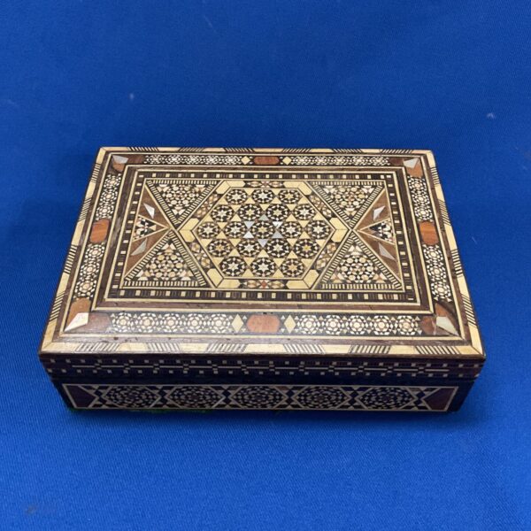 Intricate vintage marquetry trinket box with bone and mother of pearl inlay.