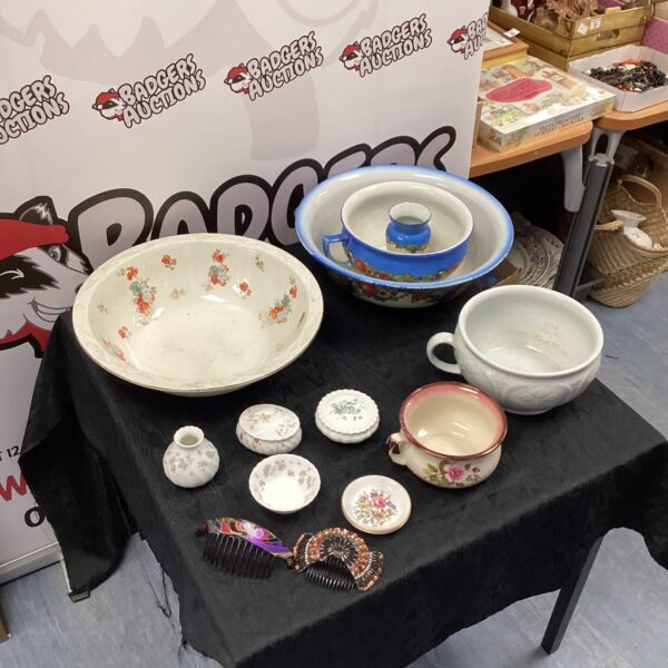 Antique porcelain chamber pots and wash basins in a collection.