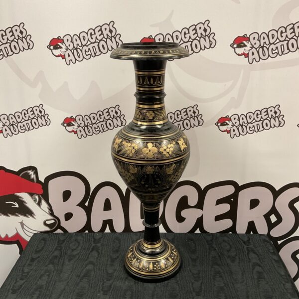 Large Indian metal vase with intricate embossed designs.