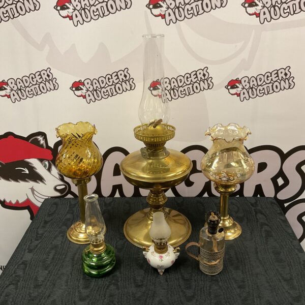 Collection of vintage oil lamps with glass and metal details.