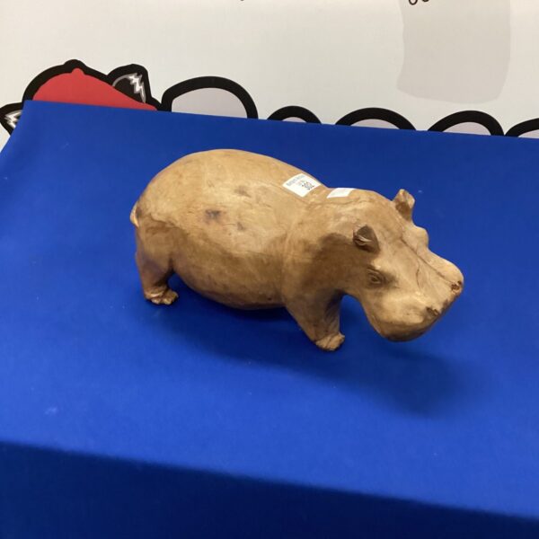 Hand-carved wooden hippopotamus sculpture, a charming folk art piece.