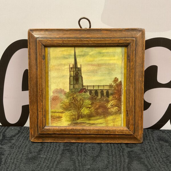 Antique Victorian ceramic tile depicting a church by a stream.