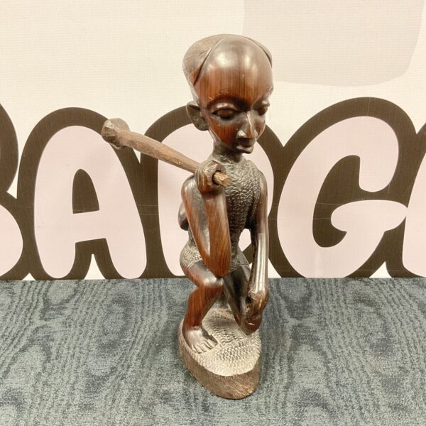 Authentic African ebony carving of a tribal boy with a club.
