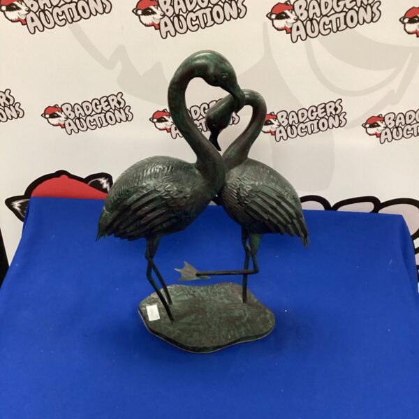 Vintage metal flamingo figurine for garden decoration.