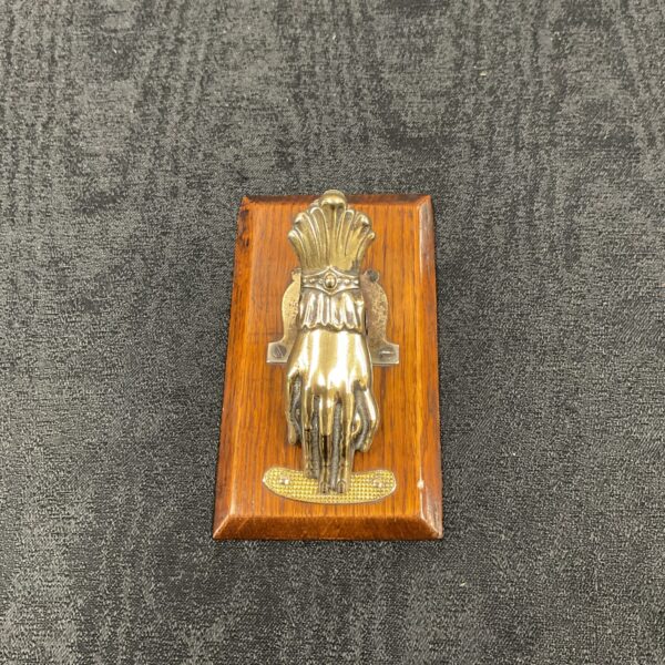 Vintage brass hand note holder on wooden base