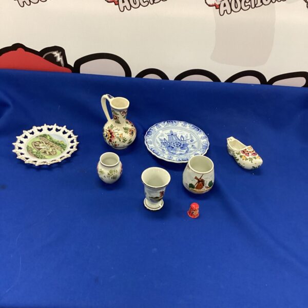 Delft pottery collection featuring a miniature shoe and vase.