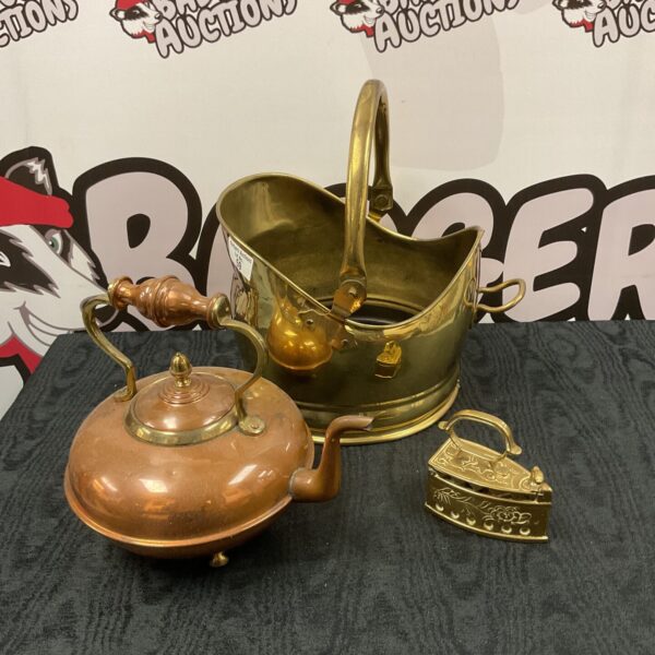 Vintage brass coal scuttle and copper kettle on display.